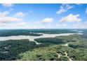 Expansive aerial view showcasing the lake and surrounding lush greenery under a partly cloudy blue sky at 327 Red Fox Dr, Canton, GA 30114