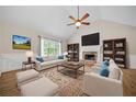 Bright living room features a fireplace, ceiling fan, built-in bookshelves, and comfortable seating at 327 Red Fox Dr, Canton, GA 30114
