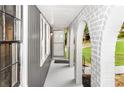 Covered porch area leading to the front door, featuring white brick arches and gray trim at 3530 Turner Heights Dr, Decatur, GA 30032