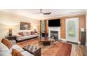 Inviting living room features a fireplace, ceiling fan, plush seating, and a neutral color palette at 2437 Charleston Pointe Se Ct, Atlanta, GA 30316