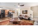Open-concept living room and dining area showcasing wood floors and abundant natural light at 2437 Charleston Pointe Se Ct, Atlanta, GA 30316