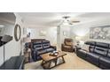 Bright and welcoming living room filled with comfortable seating, soft carpet, and decorative accents at 67 Middleton Se Ct, Smyrna, GA 30080