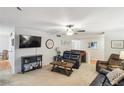 Cozy living room with a ceiling fan, soft carpet, a modern TV and an entrance to the dining area at 67 Middleton Se Ct, Smyrna, GA 30080
