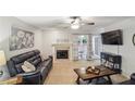 Comfortable living room with a fireplace, ceiling fan, and sliding glass doors leading to the outside at 67 Middleton Se Ct, Smyrna, GA 30080