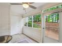 Enclosed porch with whitewashed walls and trim and a view of the wooded yard at 67 Middleton Se Ct, Smyrna, GA 30080