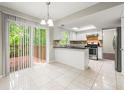 Eat in kitchen with white cabinets, stainless appliances, tile floor, and sliding doors to the deck at 1386 Heritage Glen Dr, Marietta, GA 30068