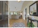 Welcoming entryway with hardwood floors, console table, and view into the living room with natural light at 2145 Charleston Oak Cir, Lawrenceville, GA 30043