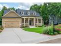 Well-maintained front exterior of a single-Gathering home with two-car garage and sidewalk at 516 Black Horse Cir, Canton, GA 30114