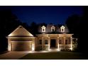 Charming single-Gathering home showcasing inviting front porch, dormer windows, and a well-manicured front yard at twilight at 516 Black Horse Cir, Canton, GA 30114