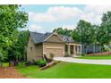 Well-manicured lawn and landscaping lead up to this single-Gathering home with two-car garage at 516 Black Horse Cir, Canton, GA 30114