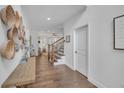 Bright hallway showcasing hardwood floors, decorative baskets and a glimpse into the living spaces at 104 Woodland Ln, Canton, GA 30114
