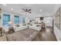 Inviting living room with natural light, neutral furniture, and an open concept to the kitchen at 104 Woodland Ln, Canton, GA 30114
