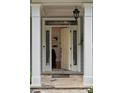 Elegant front door with sidelights, transom window, and stone entryway at 1360 Edmund Ne Ct, Atlanta, GA 30306