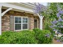 Inviting home entrance with brick accents, decorative shrubs, and a stylish front door at 1637 Short Shadow Ln, Snellville, GA 30078