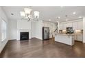 Open floor plan featuring living room, fireplace, and kitchen with stainless steel appliances at 1637 Short Shadow Ln, Snellville, GA 30078