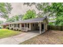 Inviting home with a covered carport, red front door, and charming front porch at 2839 Long Way, Decatur, GA 30032
