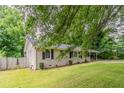 Landscaped front yard with a well-maintained lawn, mature trees, and charming brick accents at 2839 Long Way, Decatur, GA 30032