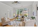Sunlit living room boasting a large window, neutral tones, and a comfortable seating arrangement at 200 Creek Run Ct, Alpharetta, GA 30005