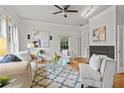 Bright living room with stylish furnishings, a cozy fireplace, and large windows that illuminate the area at 200 Creek Run Ct, Alpharetta, GA 30005