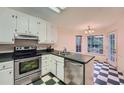 Compact kitchen with stainless steel appliances and checkered flooring at 2867 Holly Oaks Dr, Marietta, GA 30062