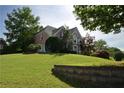 Two-story home with brick accents on a lush green, landscaped hill at 3071 Intrepid Wake, Marietta, GA 30062