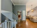 Inviting entryway featuring hardwood floors, stairs to the upper level, and open access to the kitchen at 4728 Garden Hills Dr, Stone Mountain, GA 30083