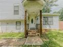 Traditional split-level home with wood porch, decorative front door and brown pillars at 4728 Garden Hills Dr, Stone Mountain, GA 30083