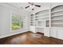 Spacious office with hardwood floors, a large window, and custom-built shelving at 1220 Roswell Manor Cir, Roswell, GA 30076