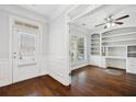 Bright home office featuring hardwood floors, built-in shelving, and wainscoting details at 1220 Roswell Manor Cir, Roswell, GA 30076