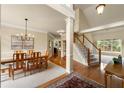 Open dining area featuring wood floors, carpet, staircase and ample light from large windows at 1995 Settindown Dr, Roswell, GA 30075