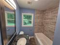 Updated bathroom with granite vanity, tiled shower, and modern fixtures, creating a relaxing spa-like experience at 2217 Sargent Se Pl, Atlanta, GA 30315