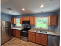 Modern kitchen featuring stainless steel appliances, granite countertops, and beautiful wood cabinets at 2217 Sargent Se Pl, Atlanta, GA 30315
