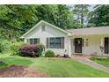 Delightful home with white siding and neat landscaping showcases a welcoming entrance and well-maintained lawn at 2440 Weatherford Ct, Marietta, GA 30068