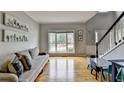 Open-concept living area with large windows, hardwood floors, and neutral wall color at 3845 Lake Lanier Dr, Duluth, GA 30097