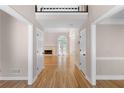 Inviting foyer with gleaming hardwood floors, leading to a spacious living area with a fireplace and lots of light at 77 Skyland Dr, Roswell, GA 30075