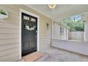 Cozy front porch with a decorative wreath on the black front door at 91 Tatum St, Marietta, GA 30060