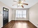 Bright living room with hardwood floors, a ceiling fan, and natural light from the windows at 91 Tatum St, Marietta, GA 30060
