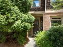Inviting front entrance featuring brick accents, a cozy porch, and mature landscaping at 1190 Hardee Ne St, Atlanta, GA 30307
