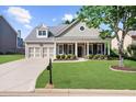 Beautiful single-Gathering home with manicured lawn, inviting front porch, and two-car garage at 100 Inspiration Ln, Dallas, GA 30157