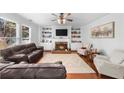 Inviting living room with a cozy fireplace, built-in cabinets, and an abundance of natural light at 100 Inspiration Ln, Dallas, GA 30157