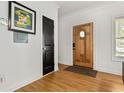 Bright entryway with hardwood floors and a decorative wooden front door at 1302 Ladd St, Atlanta, GA 30310