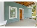 Inviting front porch with a wooden door and a stylish hanging light fixture at 1302 Ladd St, Atlanta, GA 30310