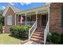Inviting front porch with white railings and brick steps leading to the entryway at 3500 Thunderwood Ln, Snellville, GA 30039