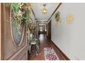 Elegant hallway featuring hardwood floors, decorative moldings, and a stylish entryway table at 3500 Thunderwood Ln, Snellville, GA 30039