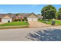 Suburban home with a well-kept lawn, driveway, two-car garage, and mature trees at 420 Spring Lake Ter, Covington, GA 30016