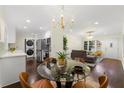 Open-concept dining area featuring modern lighting and seamless access to the living room and kitchen at 2903 Akron Street, East Point, GA 30344