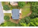Aerial view of a home showcasing its roof, deck, and spacious backyard with mature trees at 3070 Jardin Nw Ln, Kennesaw, GA 30152