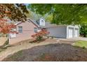 Exterior of a home with a two-car garage and a mix of brick and siding at 1545 Smoke Hill Dr, Hoschton, GA 30548