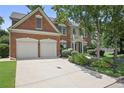 Stately brick home boasts a two-car garage, pristine landscaping, and a spacious driveway at 2023 Belridge Se Ct, Smyrna, GA 30080