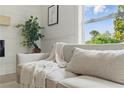 Relaxing living room showcases neutral-toned couch with throw blanket and view of the front yard at 2244 Alpha Dr, Decatur, GA 30032